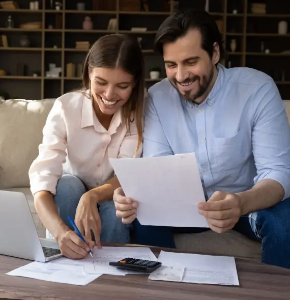 Happy Couple reviewing financial documents with a CPA for Individual Tax Preparation Services in Billings, Montana